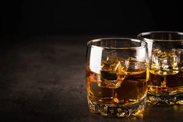 Whiskey in the glasses on black. — Stock Photo, Image