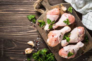 Tavuk drumctick kesme tahtası üzerinde.