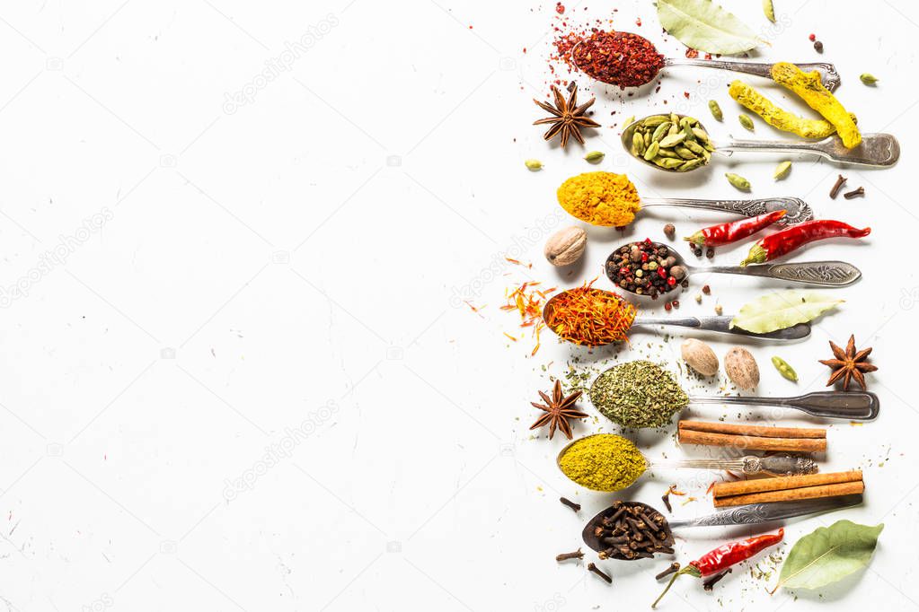 Set of various spices in spoons on white