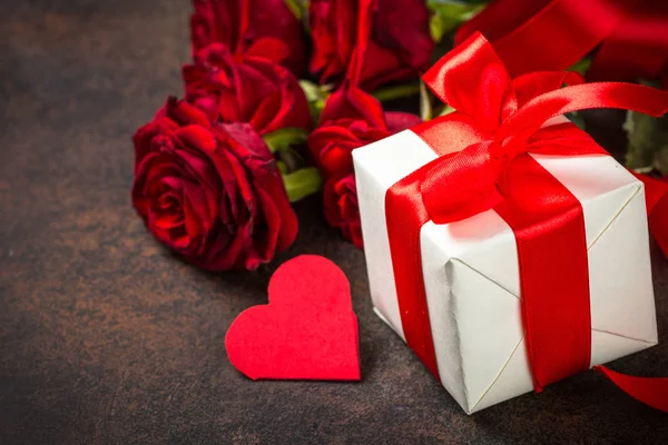 Holiday background with Valentine, present and flower.