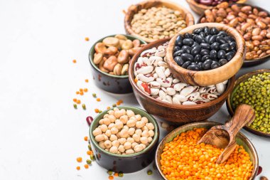Legumes, lentils, chikpea and beans assortment on white. clipart