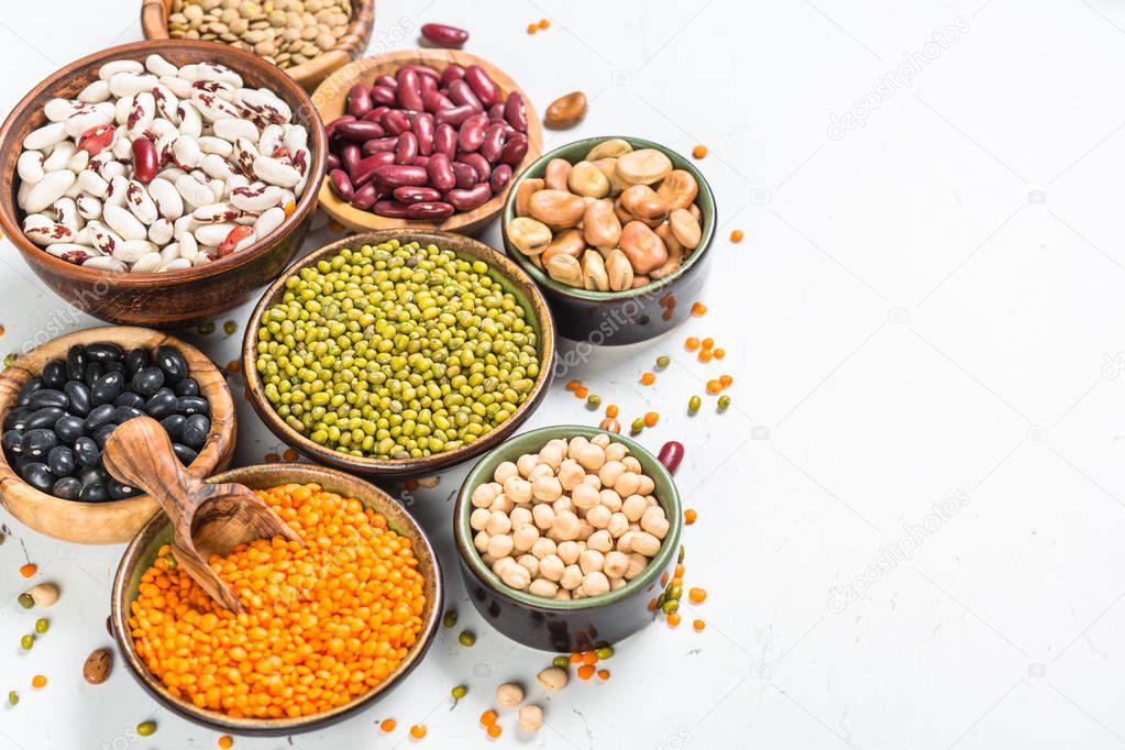 Legumes, lentils, chikpea and beans assortment on white.