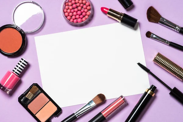 Makeup professional cosmetics on purple background.