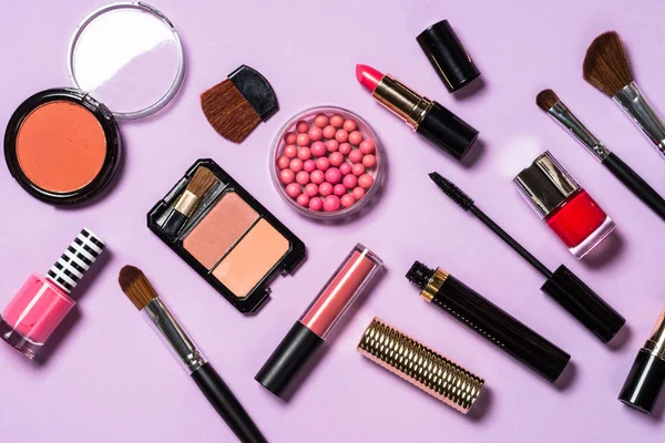 Makeup professional cosmetics on purple background.