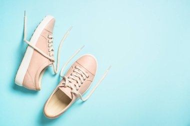 Mavi arka planda pembe kadın ayakkabıları.