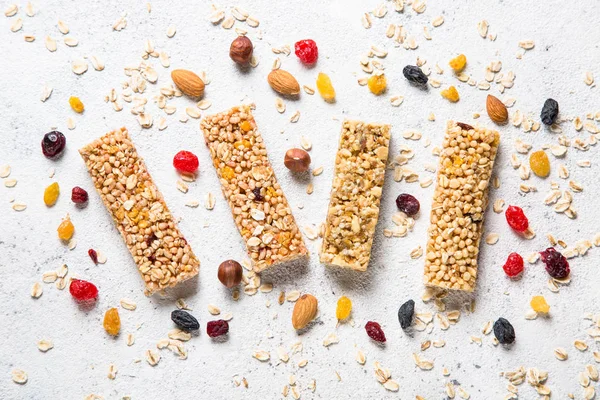 Granola bar with nuts, fruit and berries on white. — Stock Photo, Image