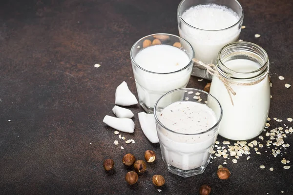 Vegan niet zuivel alternatieve melk op donkere Rusty tabel. — Stockfoto