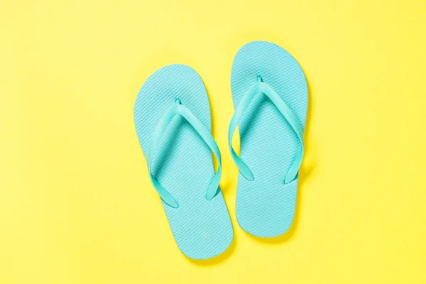 Blue flip flops on yellow background. — Stock Photo, Image