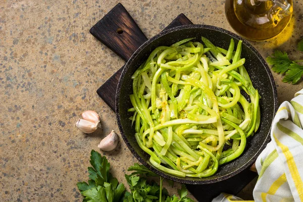 Zucchini noodles in frying pan top view. — Stock Photo, Image