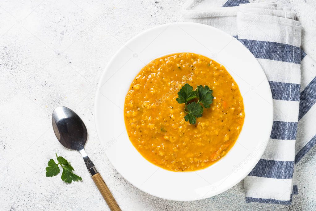 Red lentil soup on white top view.