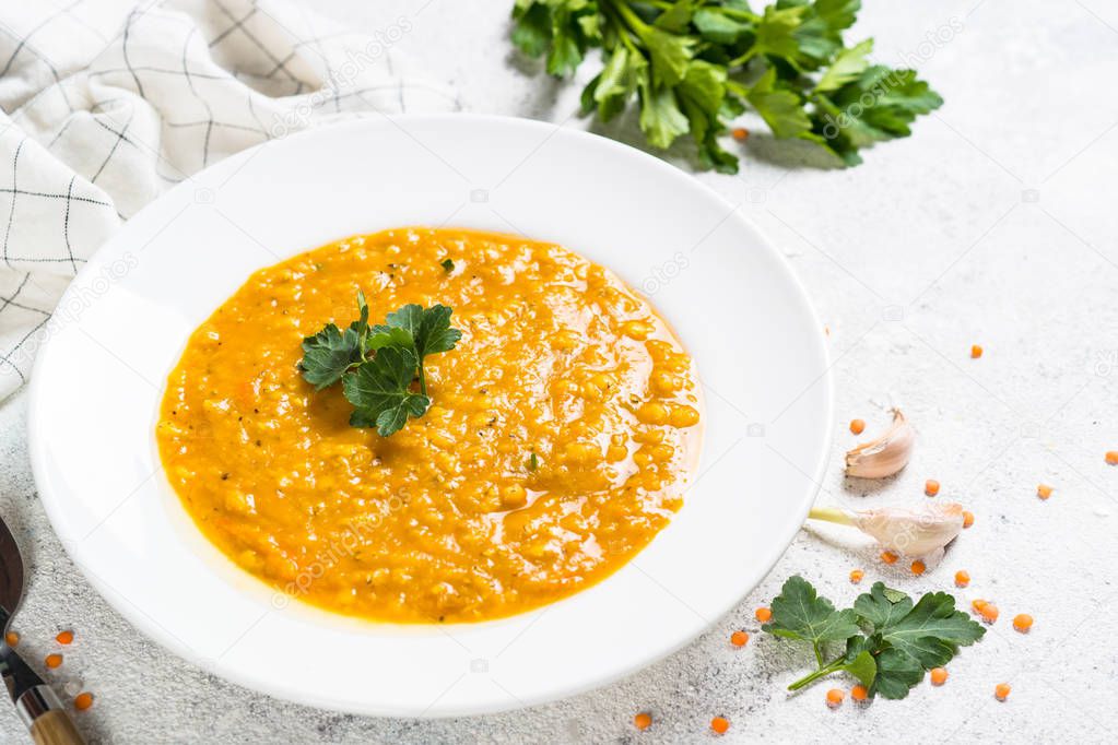 Red lentil soup on white top view.