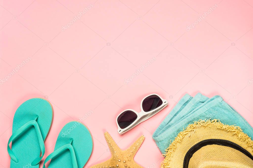 Summer holiday flat lay background on pink. Blue flip flops, sunglasses and starfish. Summer holiday concept.