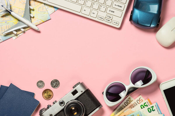 Summer travel concept on pink background top view.