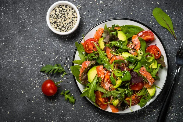 Siyah üst görünümde taze sebzeli somon salatası. — Stok fotoğraf