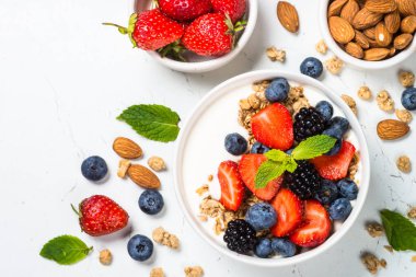 Beyaz masada taze çilek ile Yunan yoğurt granola.