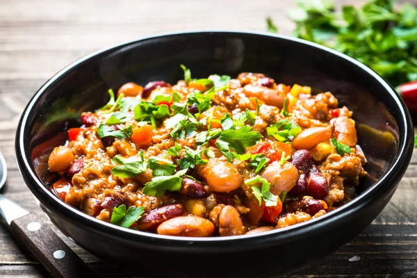 Chili con Carne aus Fleisch und Gemüse auf hölzerner Tischplatte. — Stockfoto