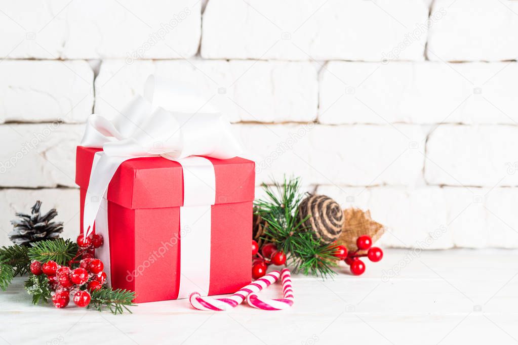 Christmas present box and decorations on white background.