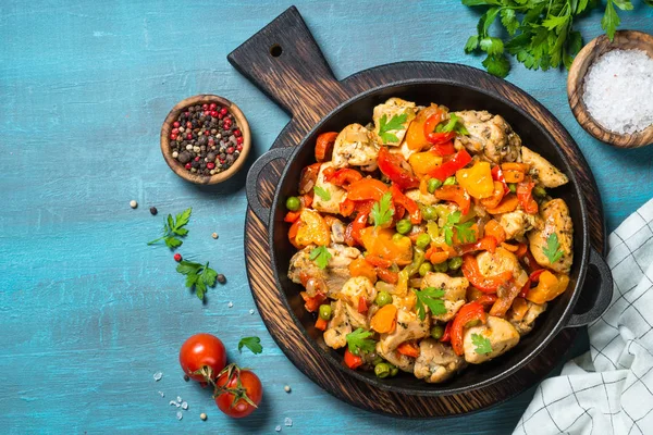 Chicken Stir fry with vegetables on blue table. — Stock Photo, Image
