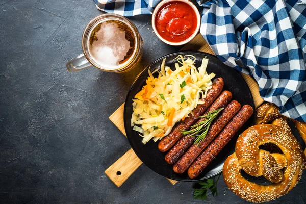 Sausage, sauerkraut, bretzels and beer. — Stock Photo, Image