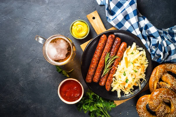 Sausage, sauerkraut, bretzels and beer. — Stock Photo, Image