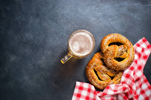 Oktoberfest food beer and bretzel on black.