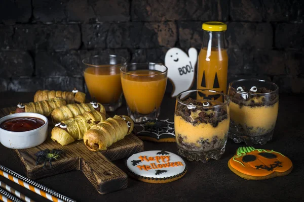 Halloween food assortment - sasage mummies, pumpkin dessert, gin