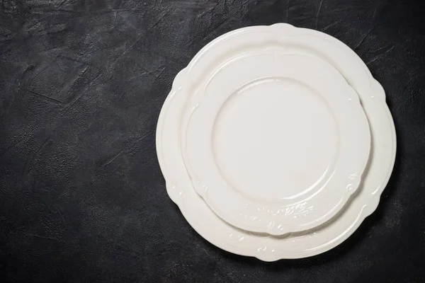 White plate on black stone table. — Stock Photo, Image