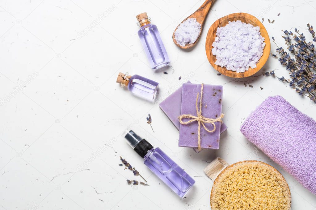 Lavender cosmetics on white top view.