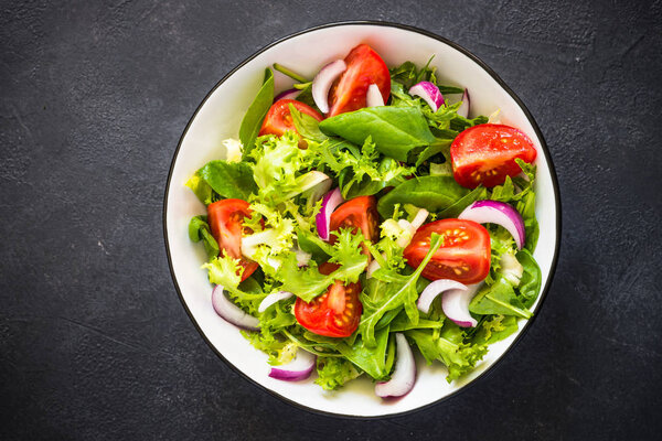 Green salad from leaves and tomatoes.