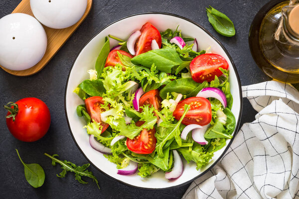 Green salad from leaves and tomatoes.