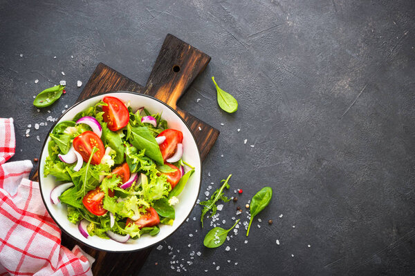 Green salad from leaves and tomatoes.