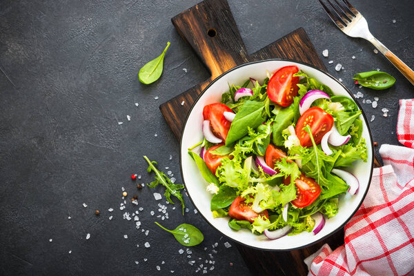 Green salad from leaves and tomatoes.