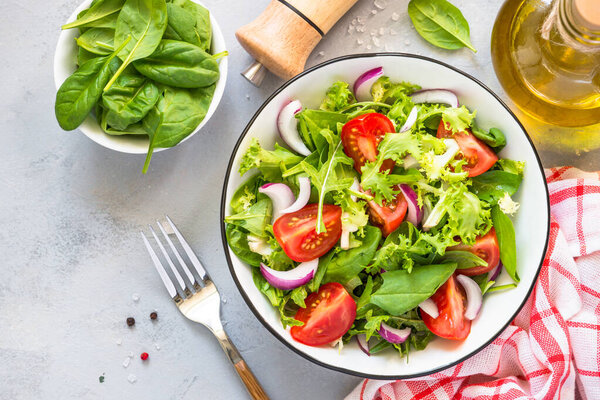 Green salad from fresh leaves and tomatoes.