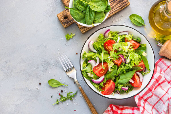Green salad from fresh leaves and tomatoes.