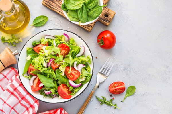 Green salad from fresh leaves and tomatoes.