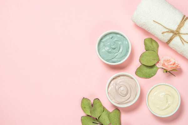 Clay mask on pink bakground, skincare product.