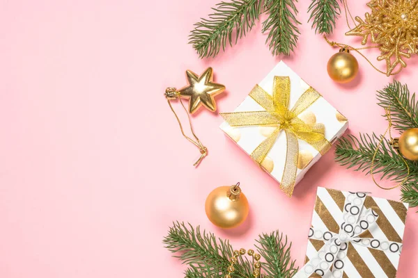 Golden Christmas flat lay background on pink with present box and decorations. — Stock Photo, Image