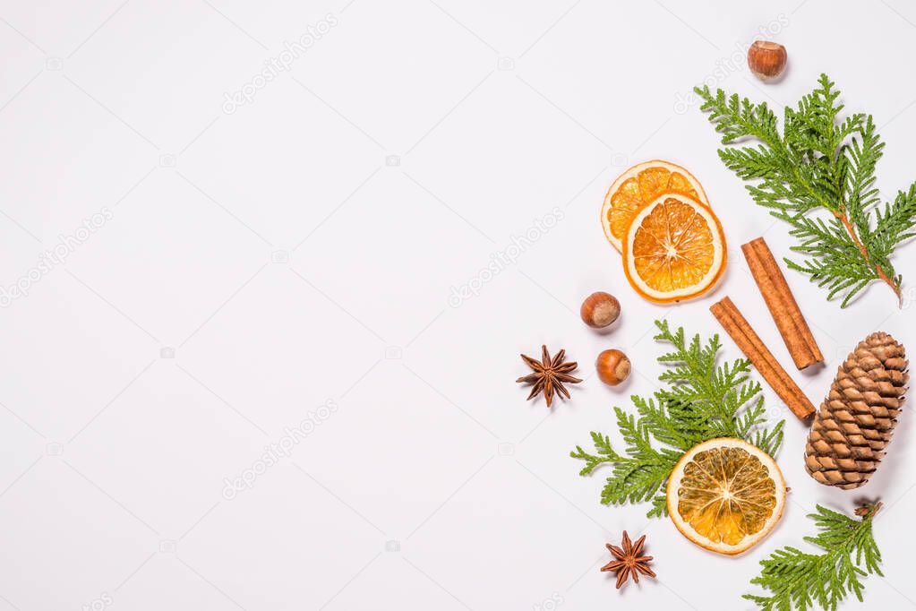 Christmas flat lay background with fir tree and spices on white.