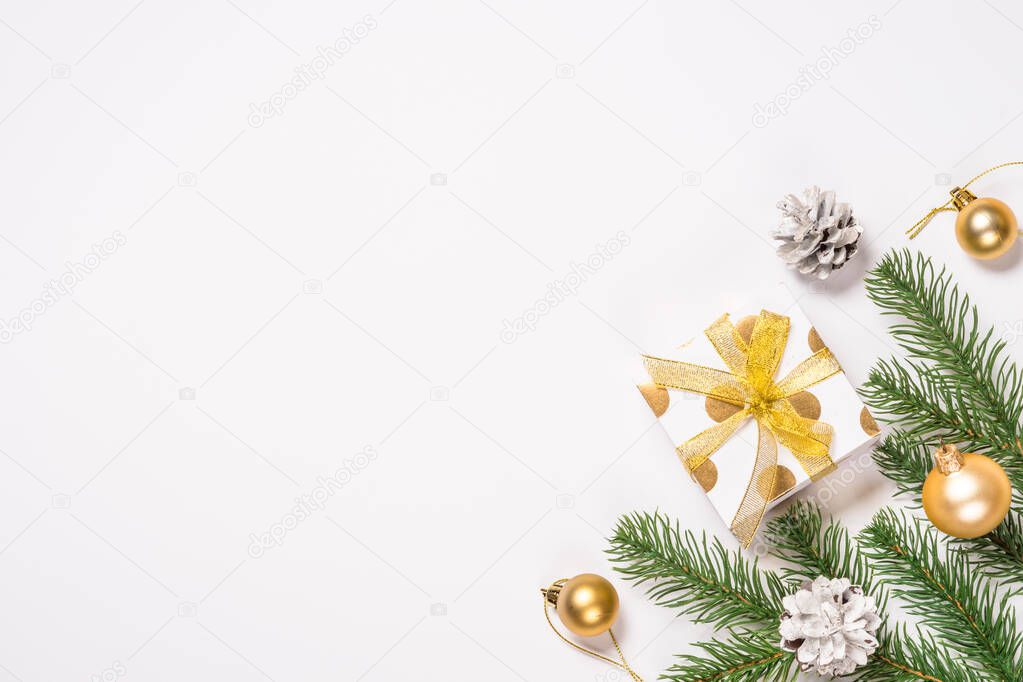 Christmas flat lay background with golden decorations on white.
