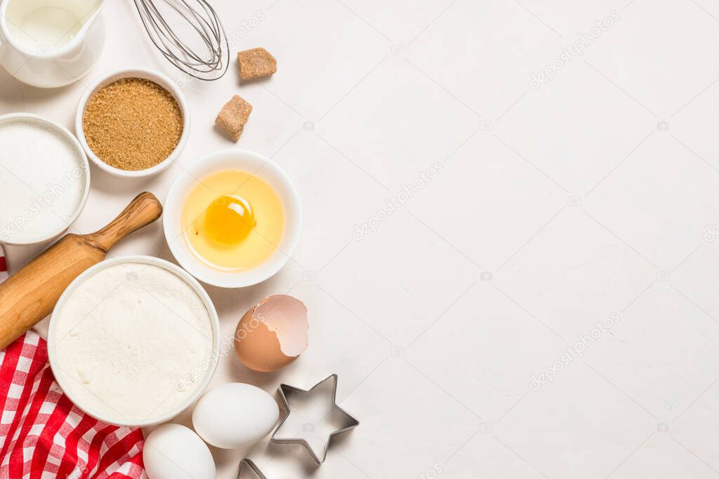 Baking ingredients at blue table top view.