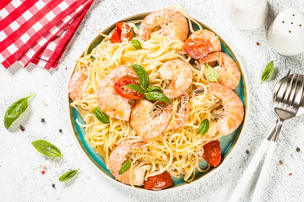 Pasta seafood with shrimp on white table.