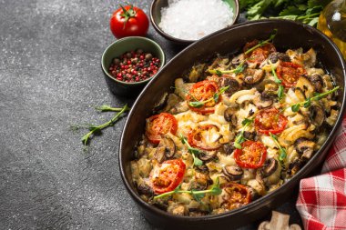 Sebzeli fırında et, siyah masanın üstünde üst görünüm..