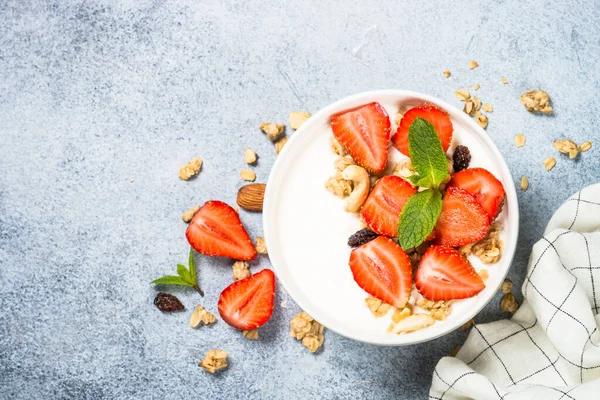Yogurt with granola and strawberry in white bowl — Stock Photo, Image