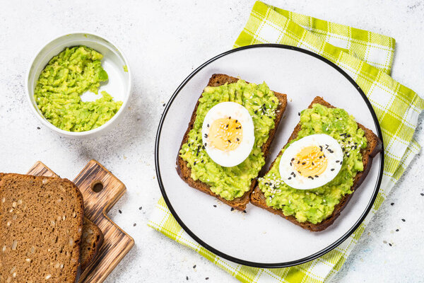 Avocado Sandwiches on white background.
