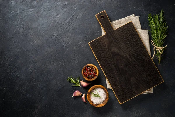 Food cooking background with herbs and spices on black. — Stock Photo, Image