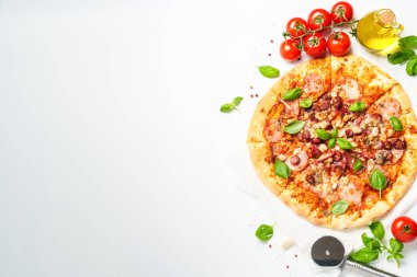 Beyaz arka planda pizza ve yemek malzemeleri. Jambonlu, salamlı ve sosisli lezzetli et pizzası. Üstteki görünüm beyaz ve metin için boşluk.