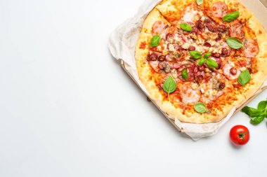 Beyaz arka planda karton kutuda pizza. Fesleğenli etli pizza. Lezzetli öğle veya akşam yemeği, fast food.
