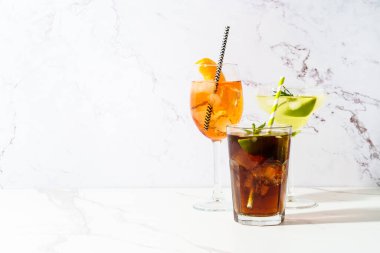 Beyaz arka planda alkollü kokteyl içecekler. Aperol spritz, Margarita, Küba libre. Güneşli beyaz arkaplan.