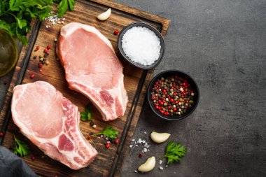 Çiğ domuz eti. Tahtada baharatlı taze et..