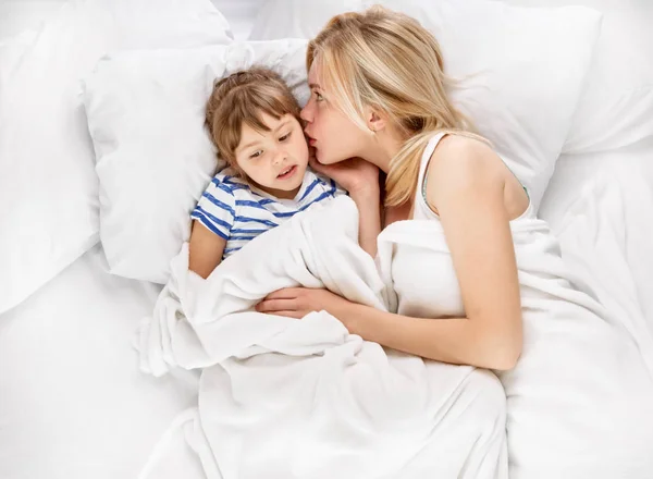 Anne ve kızı yatakta fısıldayan — Stok fotoğraf